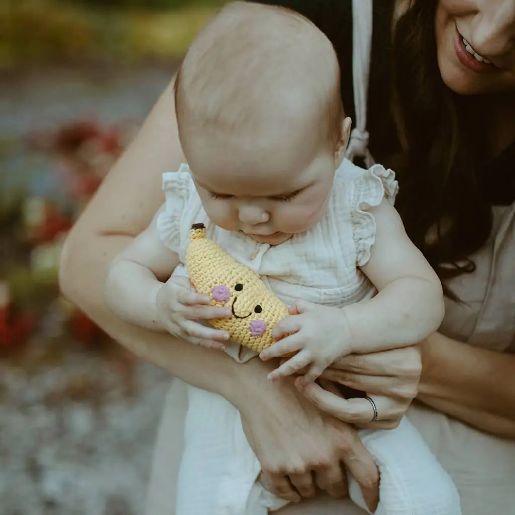 Banana Rattle Baby Toy - baby holding banana baby rattle